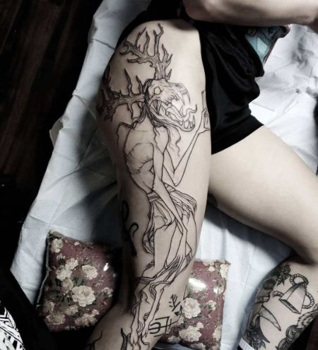 Demonic right thigh tattoo.